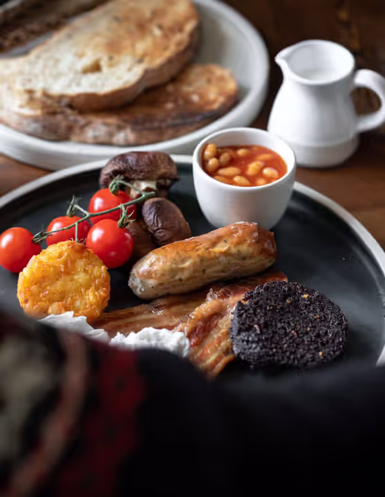 English breakfast on a plate with tea and juice