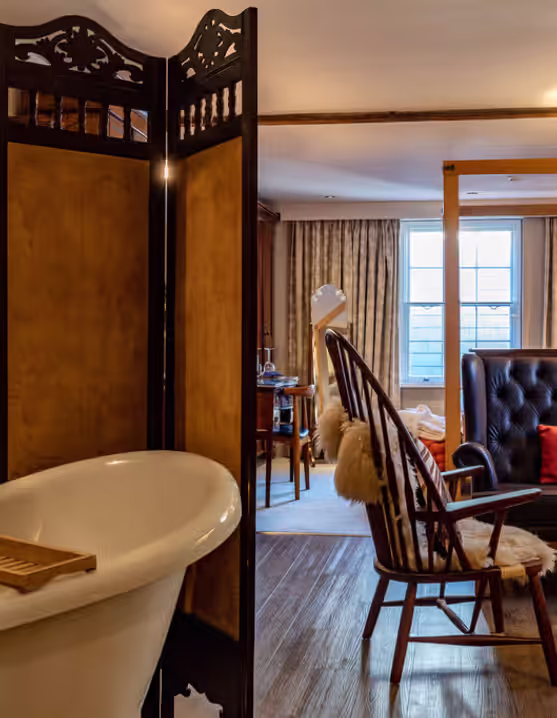 luxury suite with freestanding bathtub and leather seating