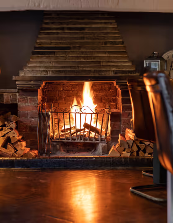 pub interior with tables, chairs, and a fireplace