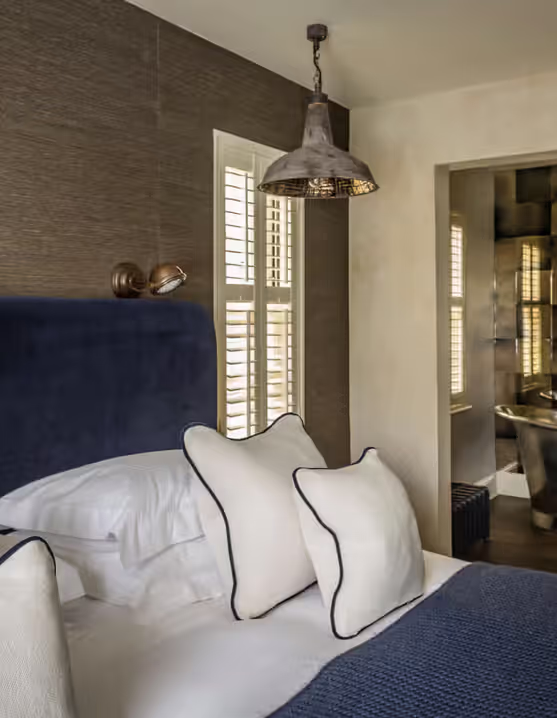 hotel room with a king-sized bed and a luxurious bathroom