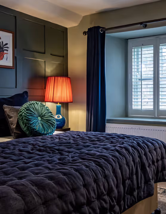hotel bedroom with blue and green decor