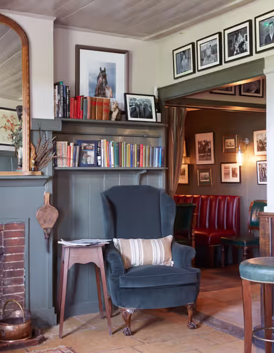 pub interior with fireplace and wingback chair
