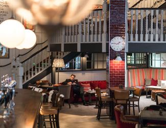 Main bar area on the main floor with staircase at the back