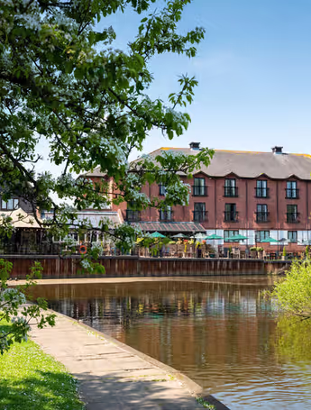 The Bridge Hotel by the river with outdoor seating