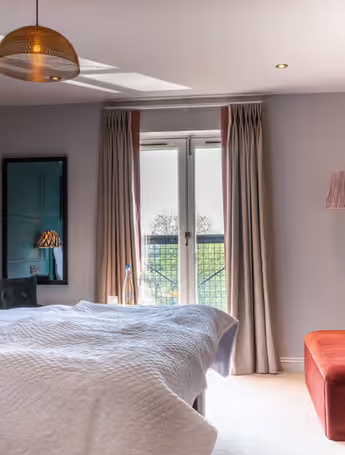 bright bedroom with a king-size bed and balcony