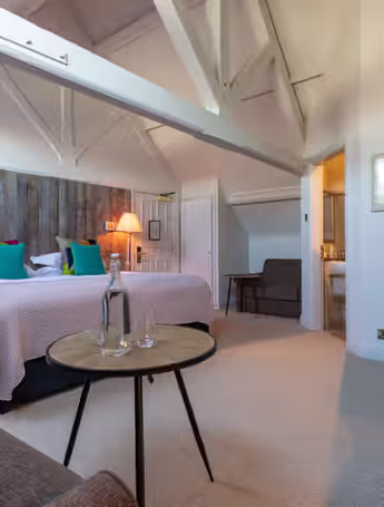spacious hotel room with king-size bed and desk