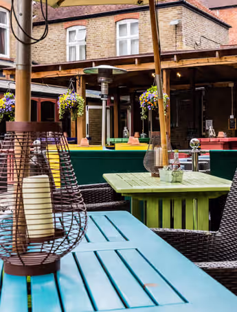 outdoor dining area with colourful tables and chairs