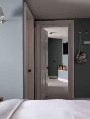 bright bedroom with a double bed and open doorway