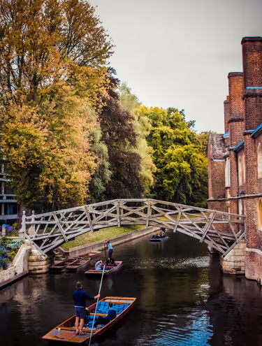 couple in small boat on river under wooden bridge
