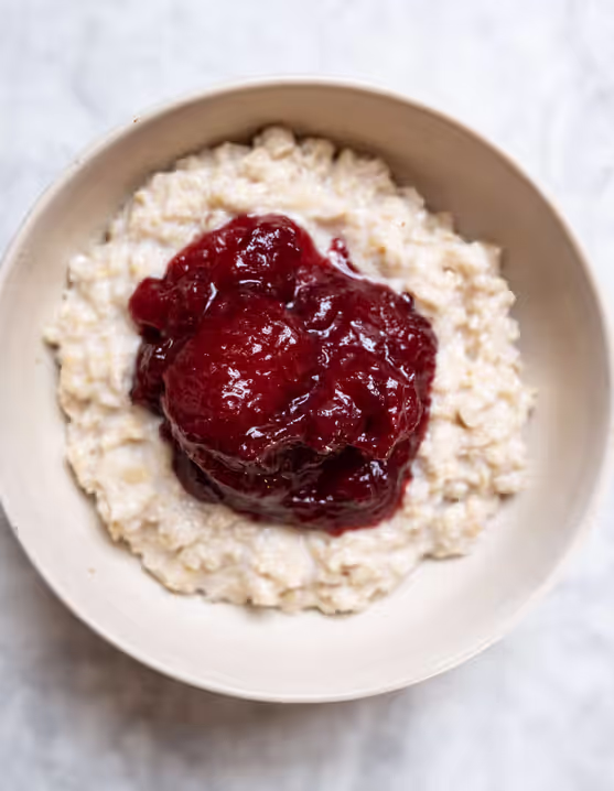 bowl of fluffy porridge topped with stewed Yorkshire rhubarb