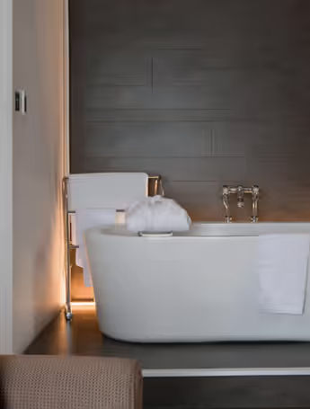 spacious bathroom with freestanding bathtub and modern fixtures