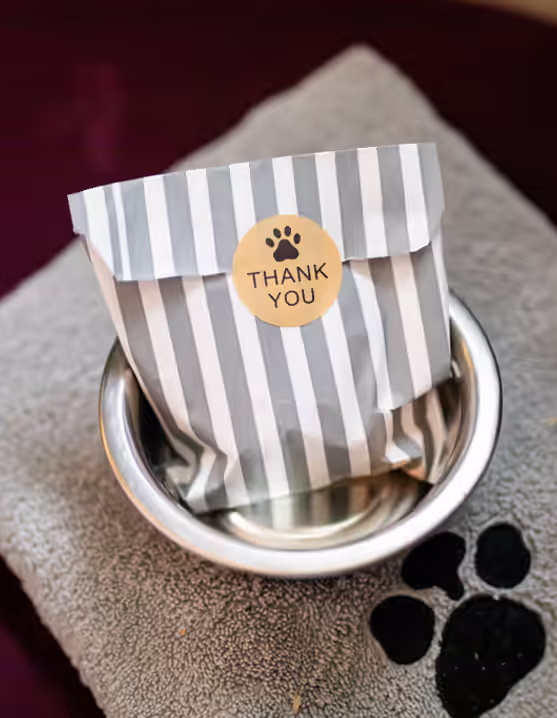 thank you gift bag sitting on a towel with a dog paw print