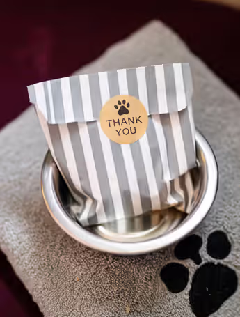thank you gift bag sitting on a towel with a dog paw print