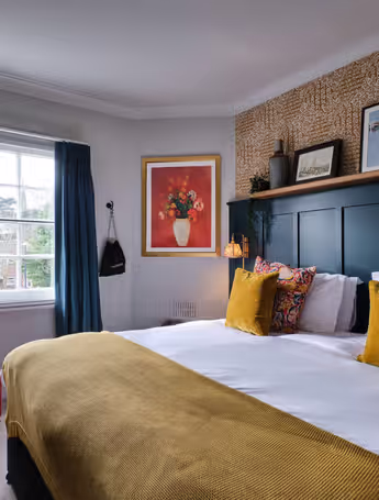 hotel room with a king-size bed and red armchair