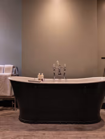black freestanding bathtub in a modern bathroom