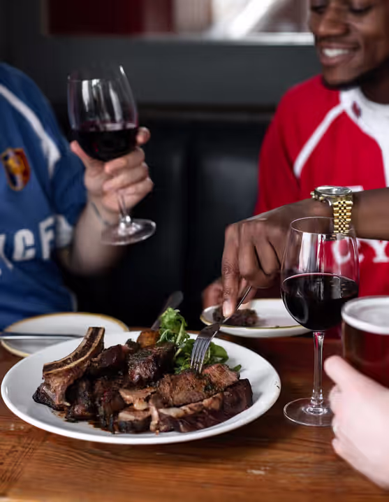 group of friends sharing a meal and wine